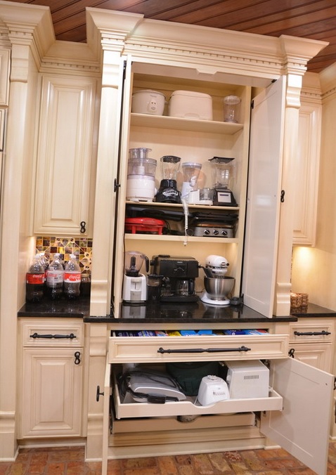 a large cabinet with shelves with appliances and drawers that hold appliances, too is a cool idea for making your kitchen more practical
