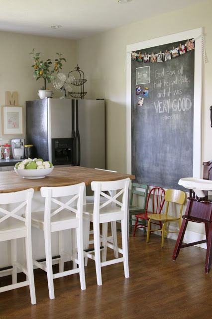 A farmhouse eat in kitchen with a large chalkboard for making notes and creating art there is very welcoming
