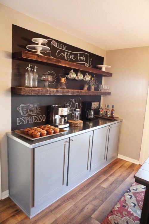 a coffee bar styled with a chalkboard wall for making notes and with rough wooden shelves looks very chic and very cozy