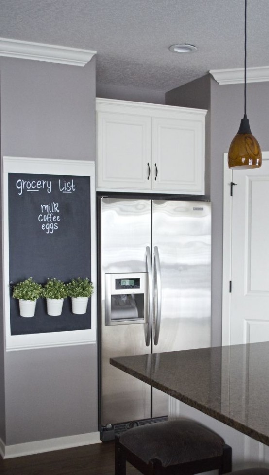 a chalkboard in a frame with some greenery is a lovely grocery list to rock in any kitchen
