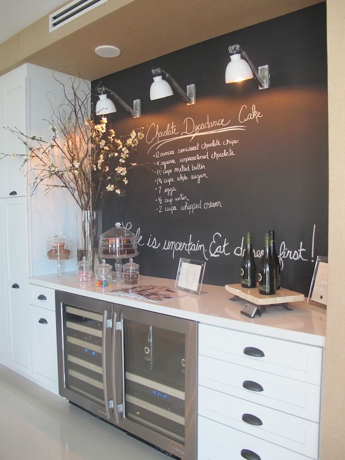 A Scandinavian kitchen with a chalkboard accent wall and backsplash in one, it contrasts the cabinets and is very practical in use