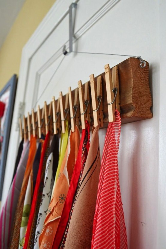 a wooden shelf on a clothes hanger and clothespins to hold your scarves and shawls