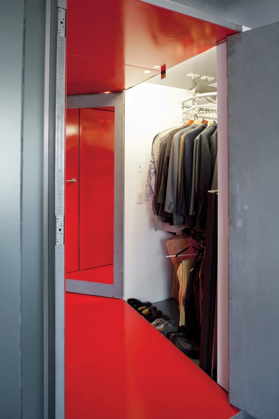a small and well-organized closet with shoes and clothes, lots of clothes hangers, and rotating shelves to accommodate more