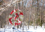 an ice piece dotted with some berries and evergreens is a nice bird feeder and just decoration for your snowy garden