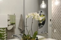 bulb-shaped sheer glass pendant lamps over the vanity for a touch of light and cool shapes are perfect
