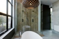 an arrangement of laser cut pendant lamps of various shapes is a stunning accent for the bathing zone