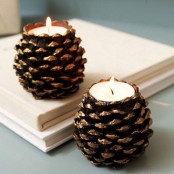 gilded pinecones turned candleholders are cool decorations to go for, you can DIY as many as you like