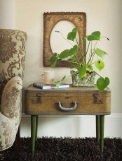 a vintage side table of a vintage suitcase placed on legs features storage and you may use the tabletop for displaying things, too