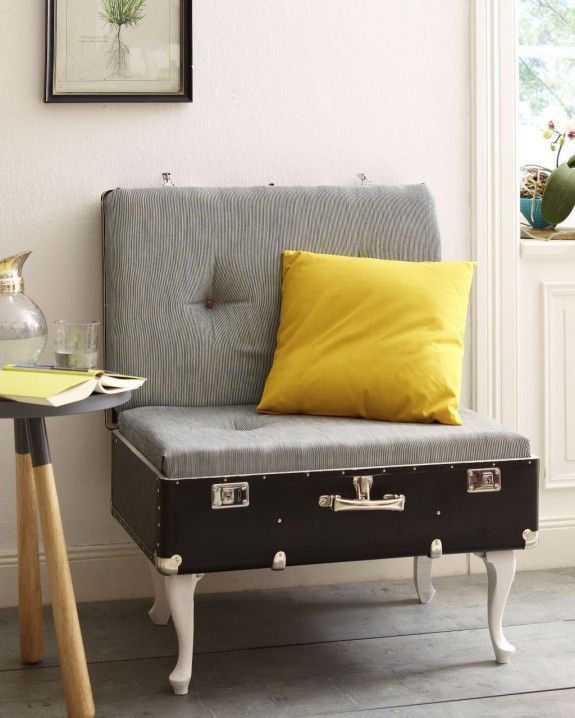A lovely chair made of a vintage suitcase placed on legs, with cushions for comfortable sitting and a bright pillow   such a cool DIY