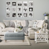 an elegant gallery wall with black and white photos framed in white is a stylish idea to rock