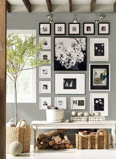 an elegant gallery wall with black and white photos in black and white frames is a stylish decoration for your home
