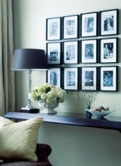 a stylish black and white gallery wall with photos in black frames is always a good idea to decorate and personalize your space a bit