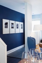 a minimalist gallery wall with black and white photos in white frames – just one row full of style