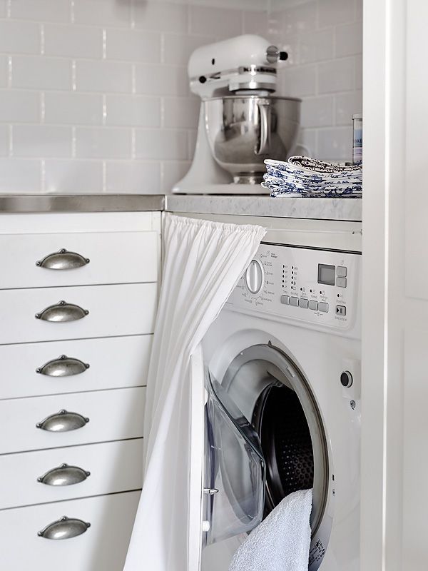 A curtain can hide a washing machine if it doesn't fully fit a kitchen cabinet.