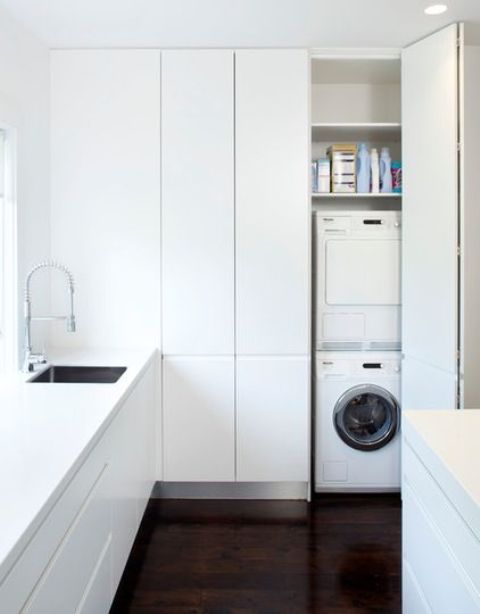 Stacking a washing machine and a dryer is a great way to fit them in a narrow but tall cabinet.