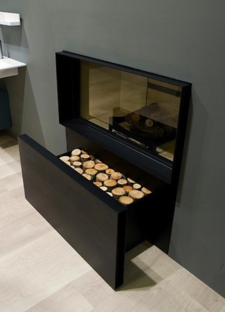 A minimalist built in fireplace with a drawer for firewood under it is a stylish and cool idea for a modern space and is very laconic
