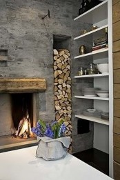 an open hearth with a wooden frame and a niche for firewood next to it, right in the wall is a very cozy and rustic idea to pull off