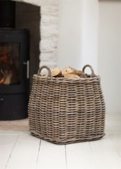a basket with firewood by the fireplace is a cool idea for literally any space and will add a bit of coziness