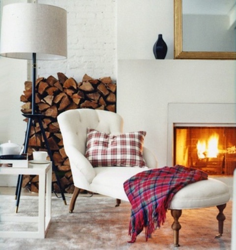 a fireplace and some firewood stored by its side is a great idea for many modenr interiors