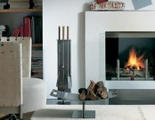 an elegant metal stand for firewood is mobile and can be placed closer to the fireplace or somewhere else and looks very minimal