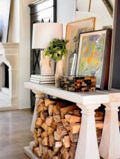 a vintage console table with firewood under the tabletop is a very cool and stylish idea for almost any space