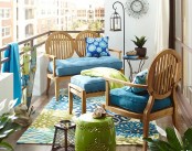 a bright and cheerful summer balcony done in blue and green, with chic vintage-inspired furniture and bright textiles