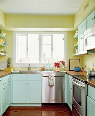 a colorful kitchen with yellow walls, blue cabinets, wooden coutnertops is a very bright, fun and stylish space