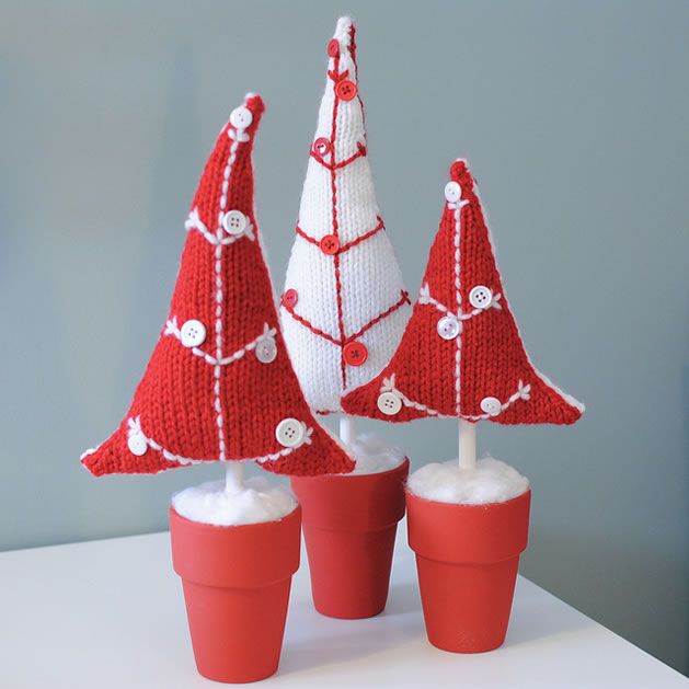 Red planters with red and white knit mini Christmas trees decorated with matching buttons are cute and non typical Christmas decorations