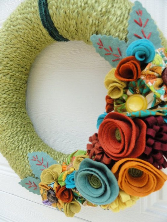 a bright fall wreath with green yarn, colorful fabric blooms and leaves is an easy DIY