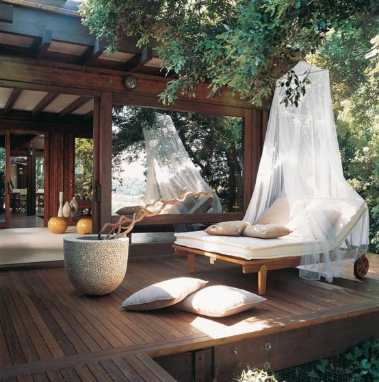 a relaxing zen terrace with a double lounger and a mosquito net for a more zen feeling and comfort
