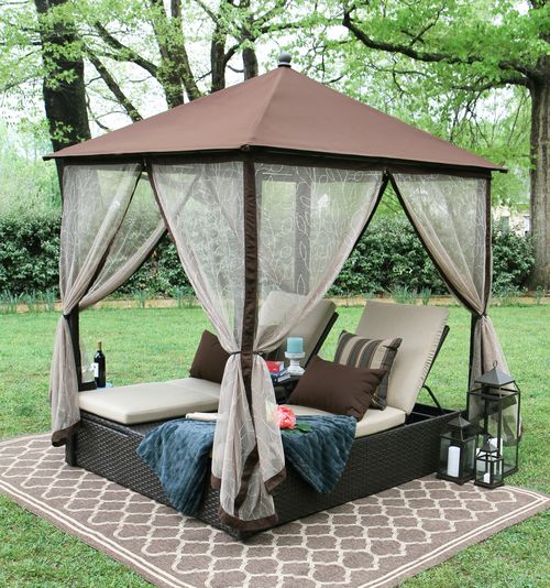 a wicker double lounger with metal roof to keep rain away and mosquito curtains to avoid bugs