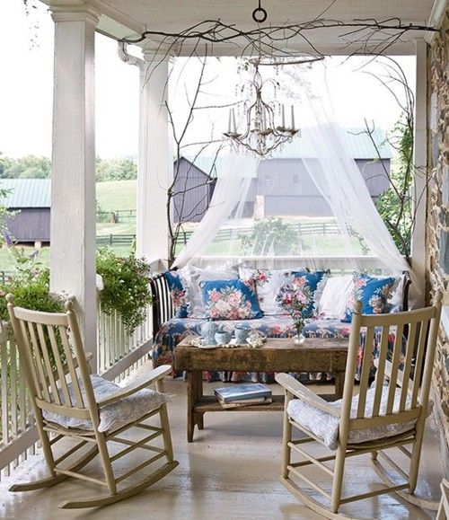 an upholstered floral bench with a mosquito net over it is a very refined idea with a touch of vintage