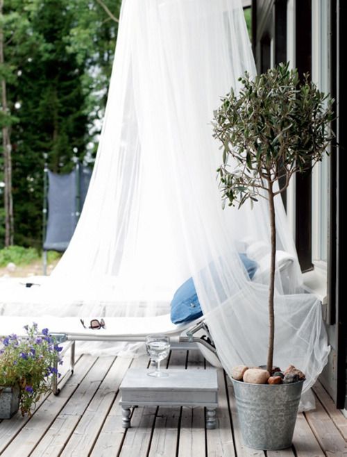 a lounger covered with a mosquito net will help you avod excessive sunshine, bugs and will give a more relaxed feel to your space