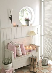 a neutral shabby chic entryway with shiplap on the wall, a porthole window, a wooden bench, potted greenery and a shutter door