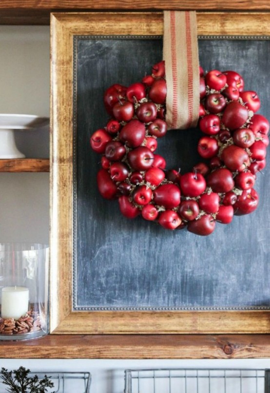 a cute and lush red apple and greenery fall wreath with a burlap ribbon is a cool rustic decor idea