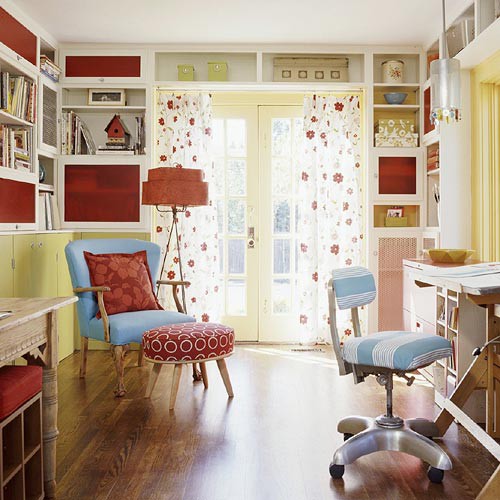 a colorful vintage-inspired home office with neutral walls, red storage units, yellow touches here and there and blue and red chairs