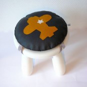 a white IKEA Mammut stool with an airplane cushion on top is a creative idea for a boy’s room