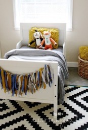 a cozy kids’ room with a printed rug, a white Sundvik bed and colorful touches is a welcoming area
