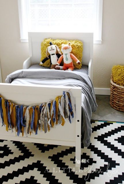 a cozy kids' room with a printed rug, a white Sundvik bed and colorful touches is a welcoming area