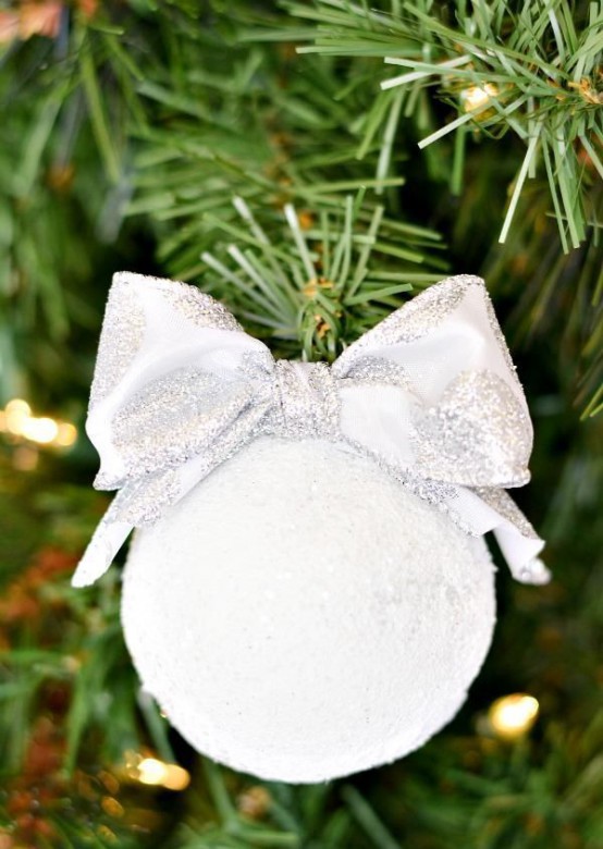 a snowball with a silver bow is a cool and cute Christmas ornament to rock