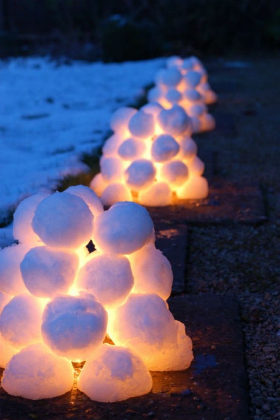 snowball and light piles for decorating outdoors, to line a path and make it look very Christmassy