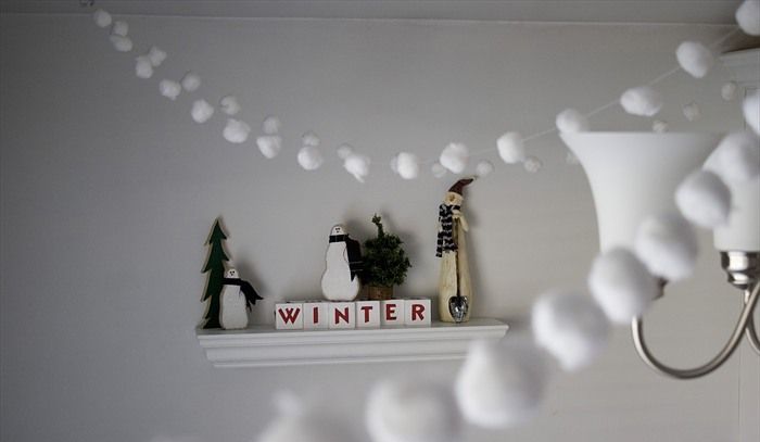 White snowball garlands over the space bring a cozy winter feel to any space and are easy to make