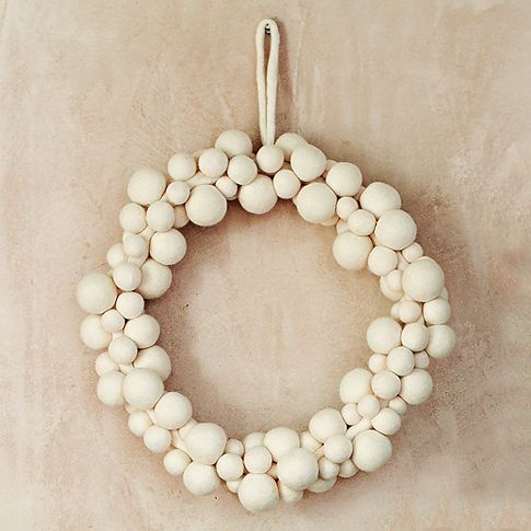 an elegant white snowball Christmas wreath is a simple and cool decoration for your front door