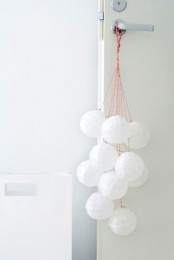 snowballs hanging on the door are a cool and cute way to add a winter feel to the space
