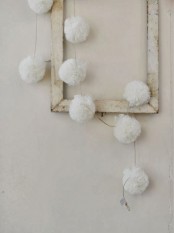 a frame with white snowballs is a shabby chic decoration for Christmas