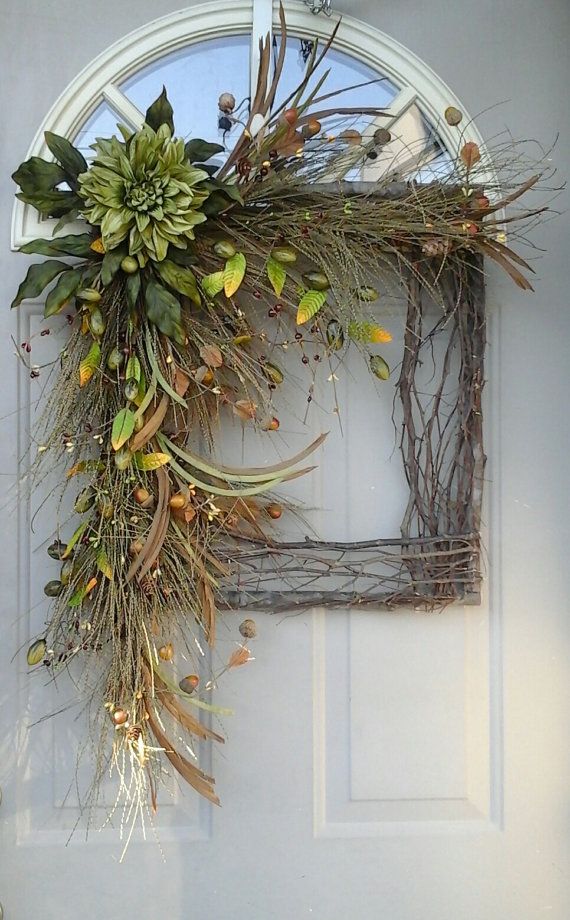 A lush fall wreath of vine, twigs, faux greenery, berries, leaves and blooms is a cool and long lasting decoration for the fall