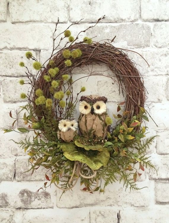 A fall woodland wreath of vine with twigs, greenery, faux leaves and owls is a nice nature inspired decoration