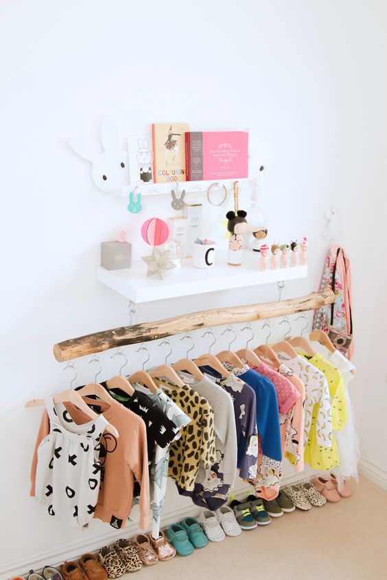 a wooden beam with lots of clothes hangers looks very neat and chic