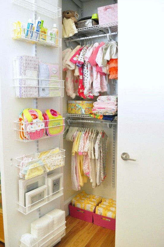 A well organized closet with wire baskets on the door, boxes and clothes hangers