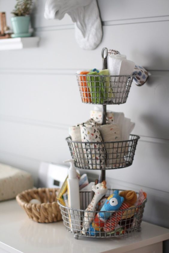 a stand with wire baskets is a nice idea for storage, place it on your changing table